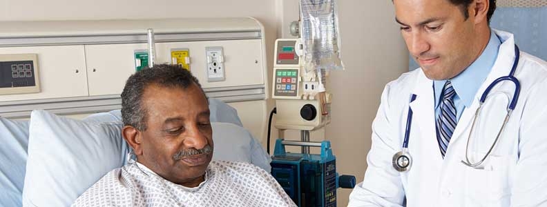 Man in hospital bed next to male doctor