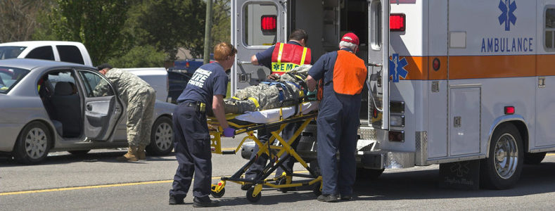 Accident victim behind loaded into an ambulance by EMS personnel