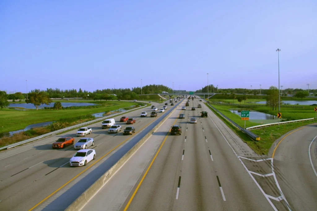 Overhead view of a busy multi-lane highway in Pompano Beach, Florida, illustrating the heavy traffic and potential risks for truck accidents