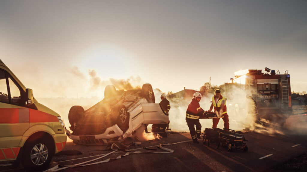 Scene of an overturned vehicle with emergency responders assisting victims after a severe truck accident in Boca Raton