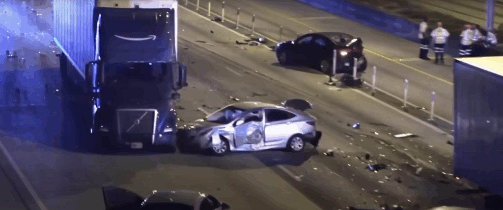 A chaotic nighttime scene on a highway with a tractor-trailer crashed into multiple vehicles, surrounded by emergency lights and people.