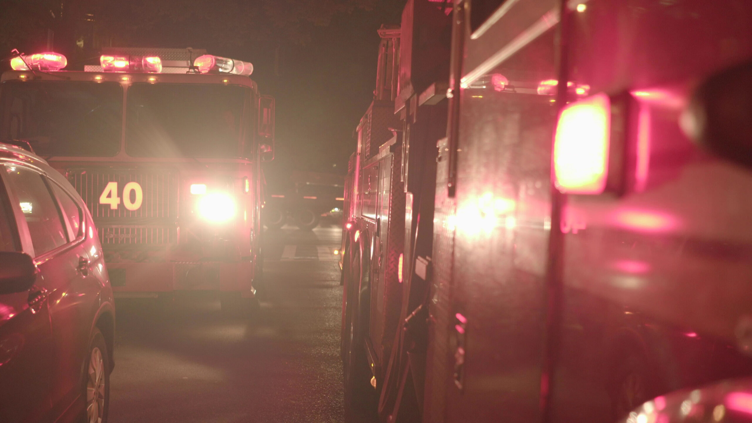 Emergency fire trucks at a nighttime crash scene on I-95 near Melbourne, Florida, assisting car accident victims.