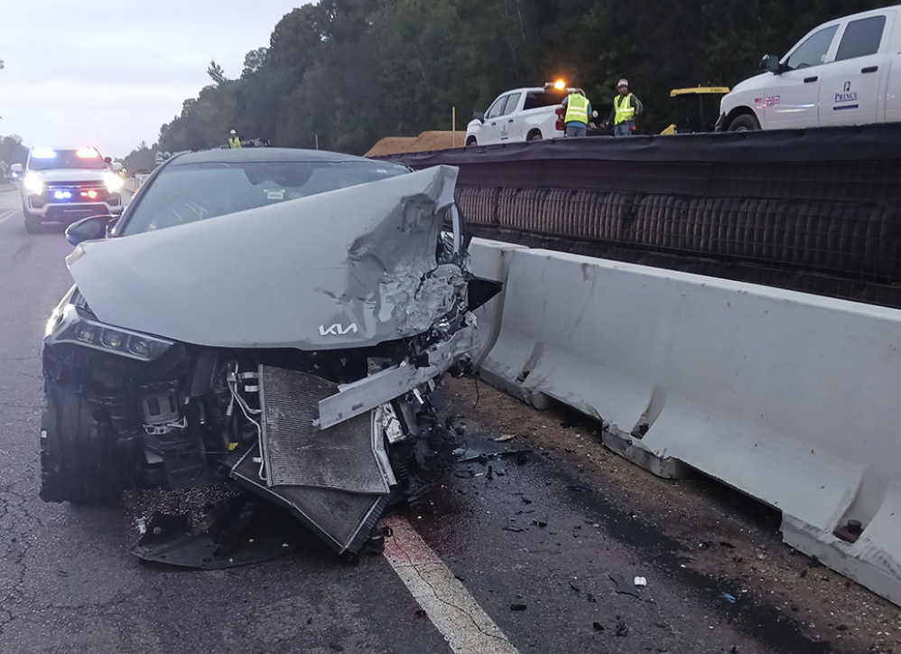Severely damaged silver Kia crashed into concrete barrier on US-98 after multi-vehicle collision in Spring Hill, Florida.