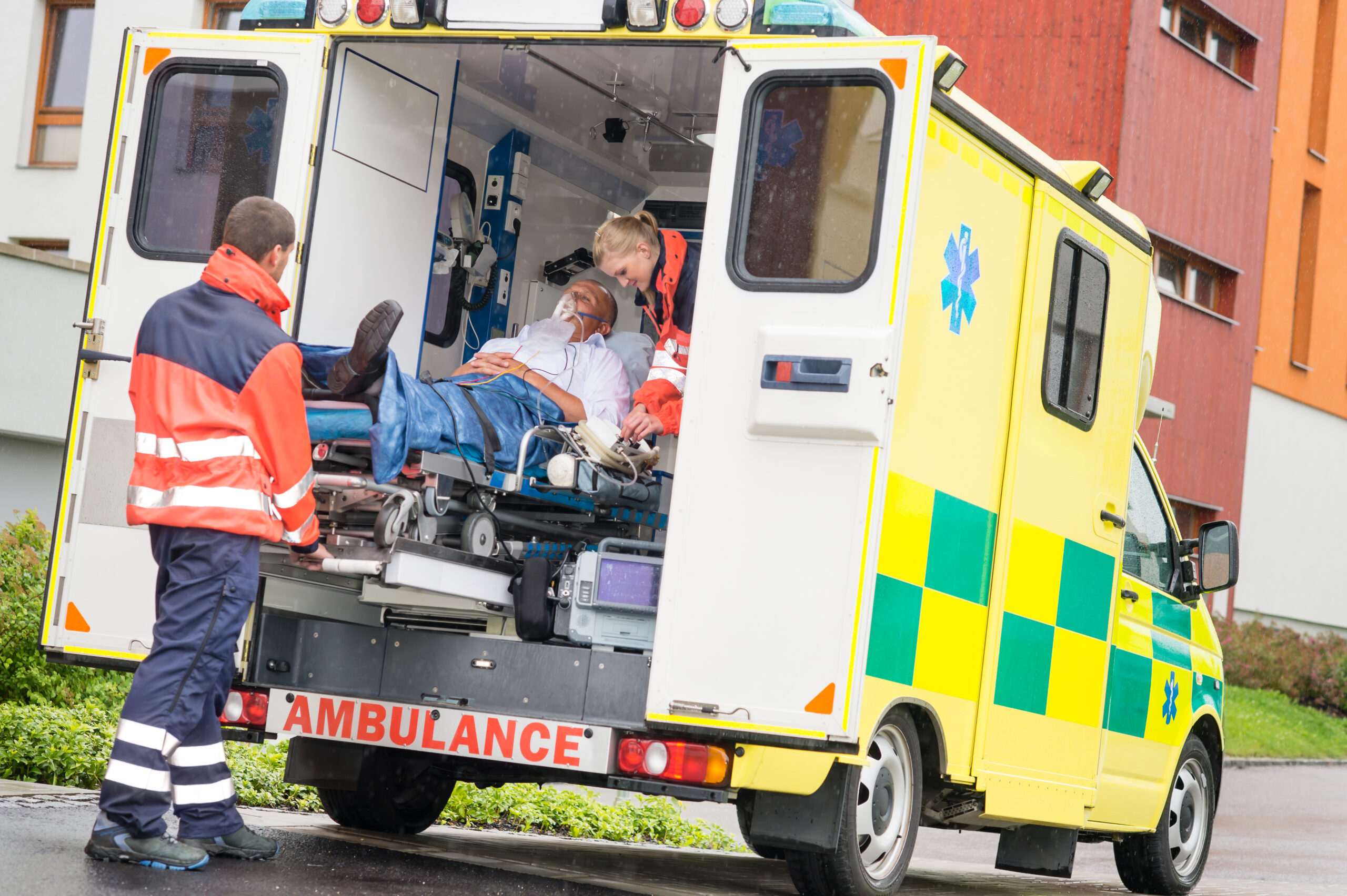 Paramedics load an injured patient into an ambulance after a Parkland accident, highlighting the urgency of seeking legal help from Kaiser Romanello Accident & Injury Attorneys.