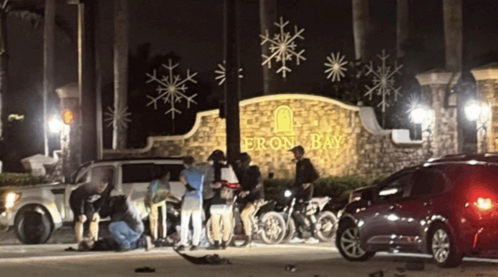 Emergency responders attend to injured e-bike riders after a vehicle collision at Heron Bay entrance in Parkland, Florida at night.