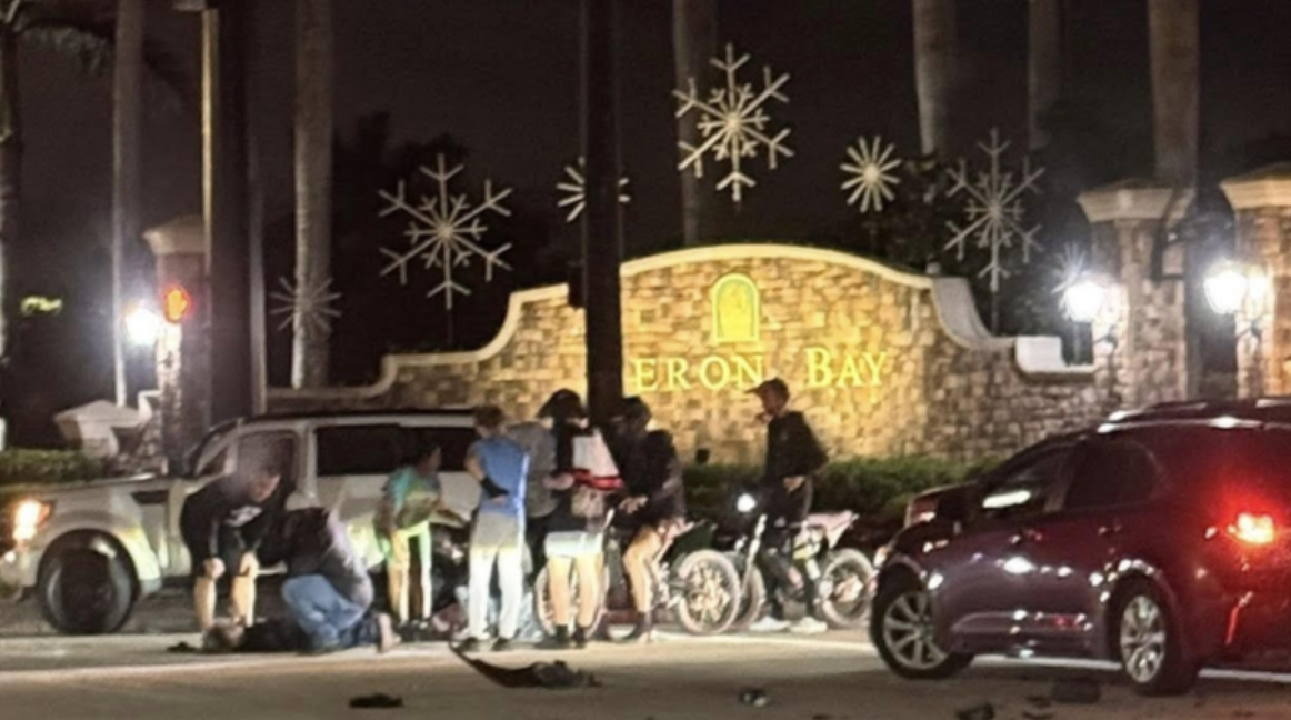 Emergency responders attend to injured e-bike riders after a vehicle collision at Heron Bay entrance in Parkland, Florida at night.