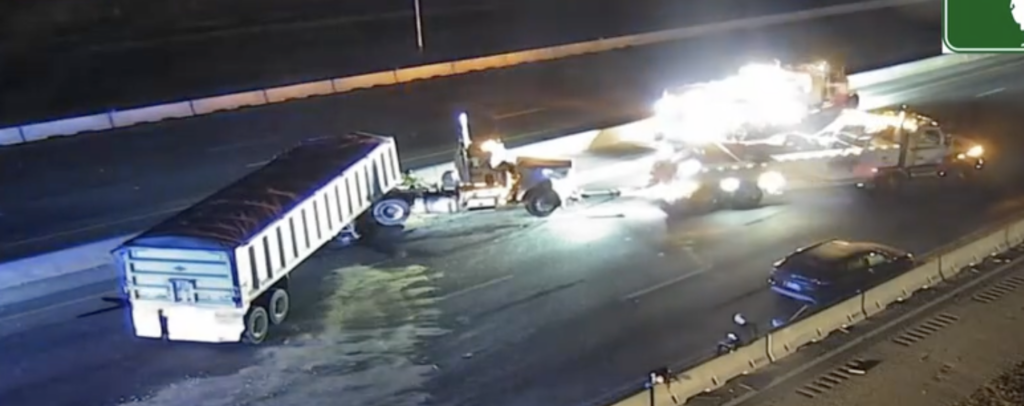 Nighttime multi-truck crash on Florida's Turnpike in Orlando with wrecked semi-trucks, debris, and emergency lights.