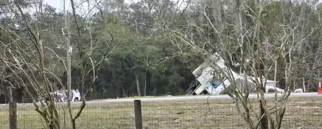 Overturned white motorhome on the side of U.S. 27 in Marion County following a fatal rollover crash involving 15 people.