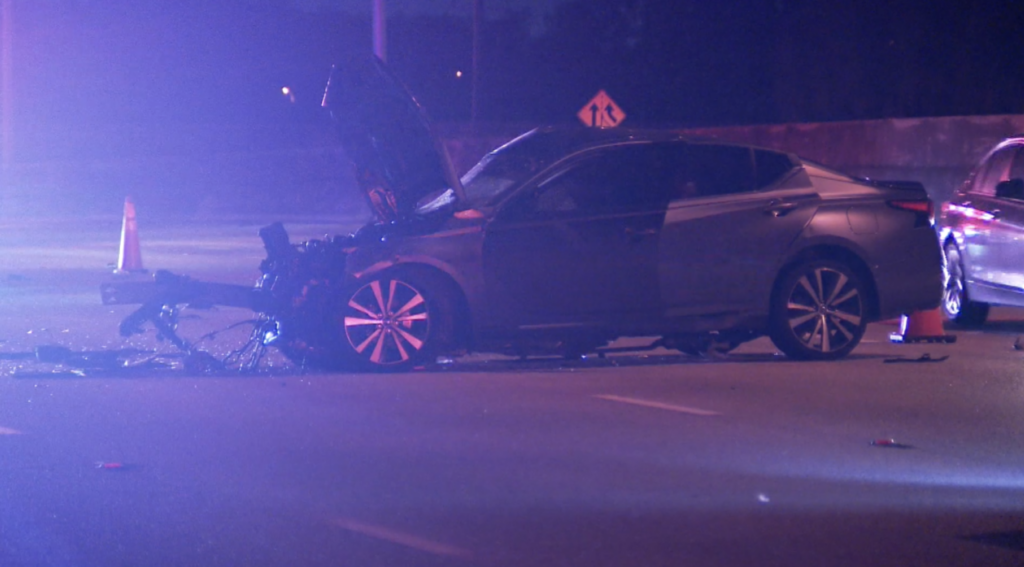 Damaged Nissan Altima with front-end wreckage on I-95 in Riviera Beach after fatal multi-vehicle crash at Blue Heron Boulevard