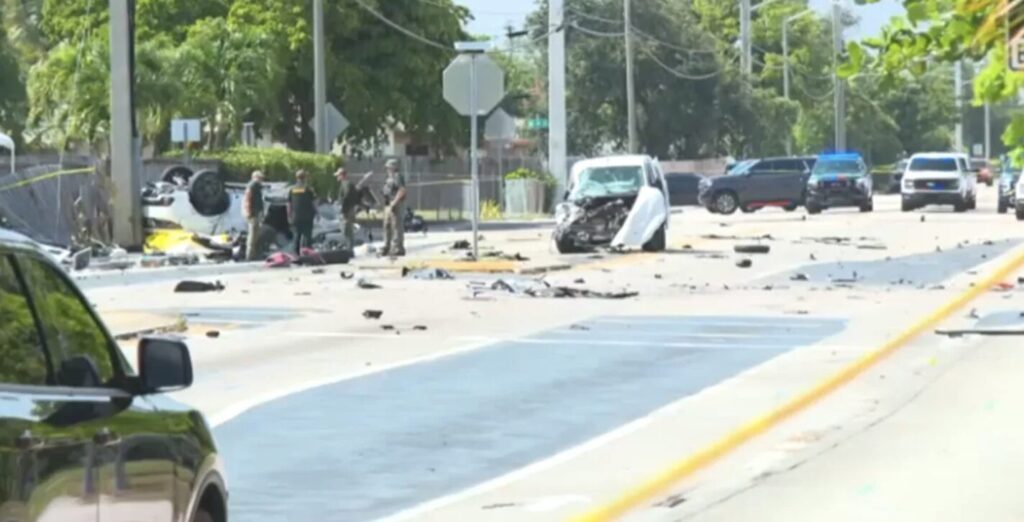Overturned SUV and damaged white van with debris scattered across Northeast Third Avenue in Deerfield Beach after fatal three-vehicle crash